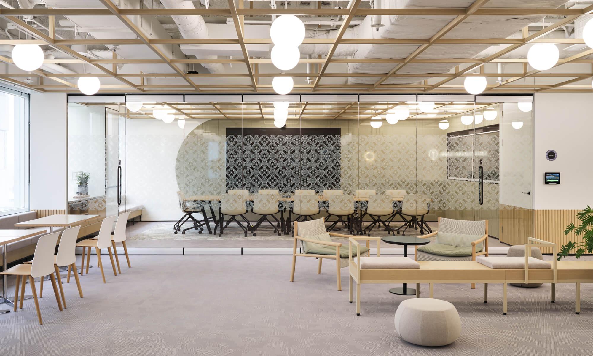A sand-toned open office space with a lounge, seating area and a meeting room.