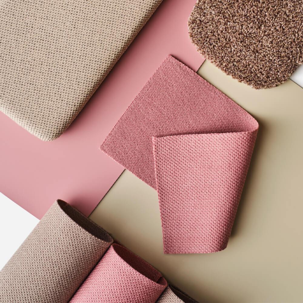 Close up of blush and neutral toned fabric samples.