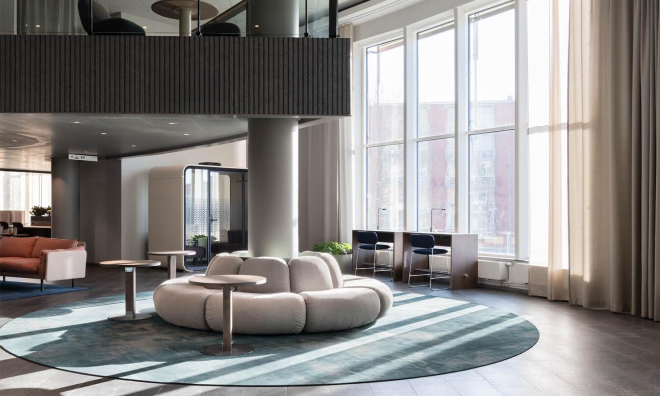 A stylish open office lobby with big sunny windows.
