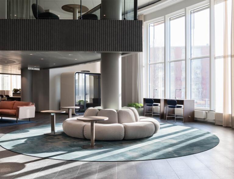 A sunny office lobby with big windows.