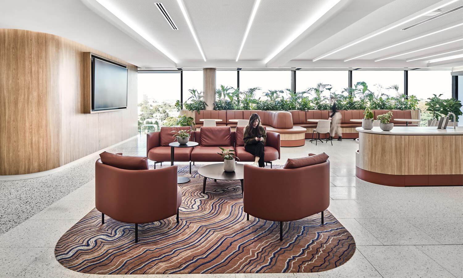 A wood-toned light and modern office lobby.