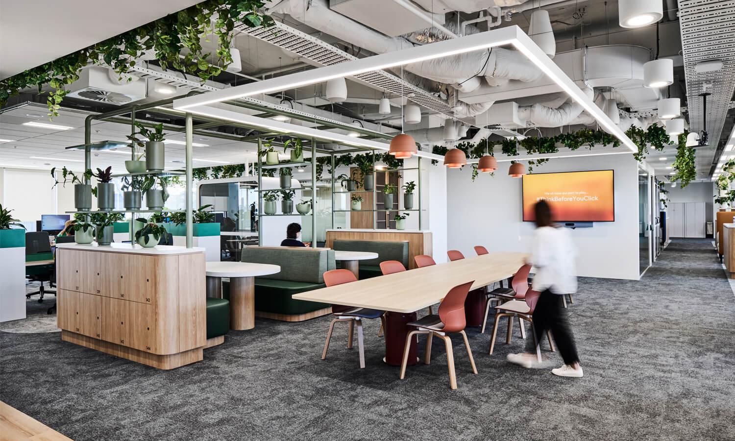 A modern office open area with wood and green tones.