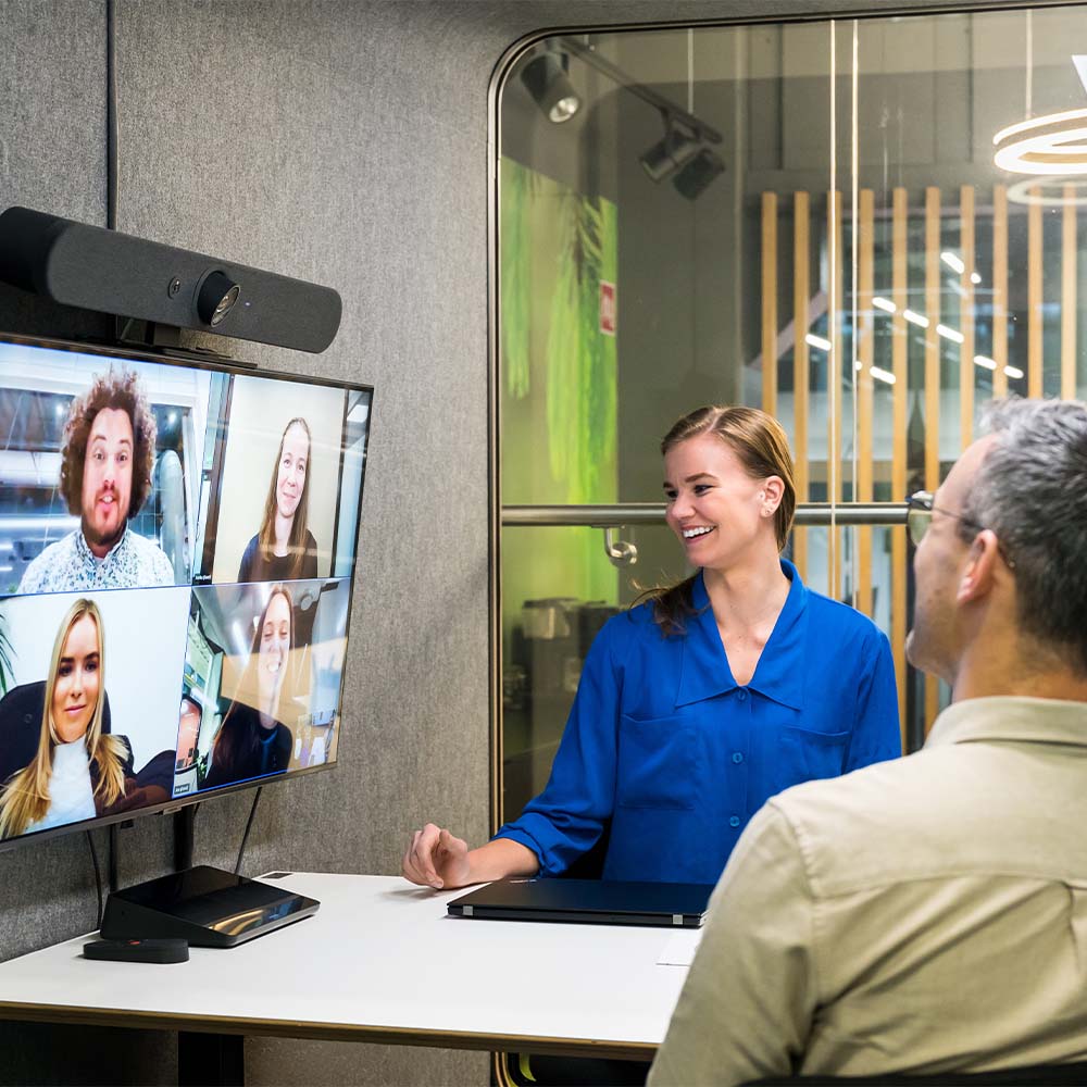 Multiple people having a video conferencing meet with colleagues working remotely.