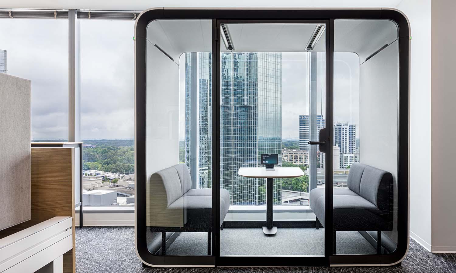 Framery Four meeting pod next to a large window in JLL's Atlanta office.