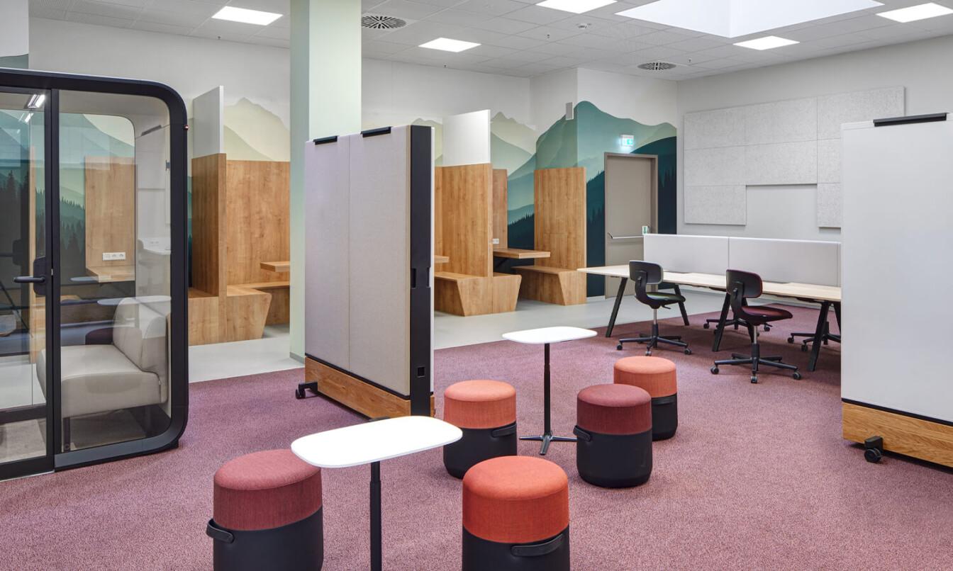 Modern study space with flexible seating, soundproof pod, partition boards, and wooden accents. Mural-like mountain scenery enhances the calming atmosphere.