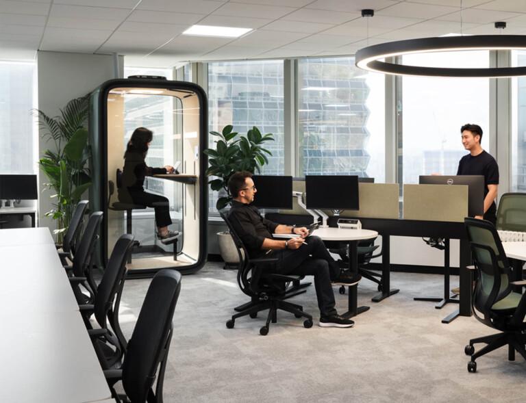 Office view with a smart pod and desks and chairs.