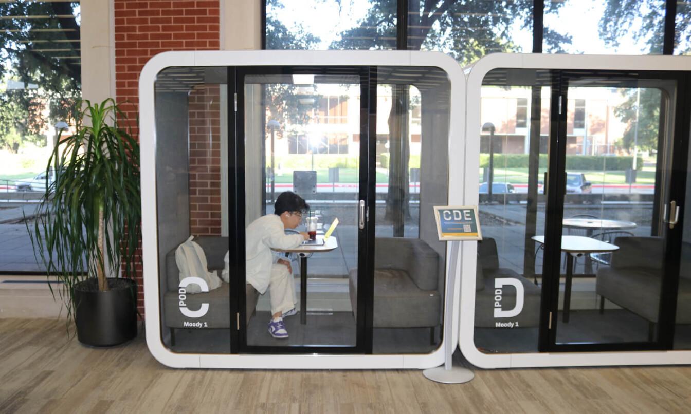 Two study pods in front of a window.